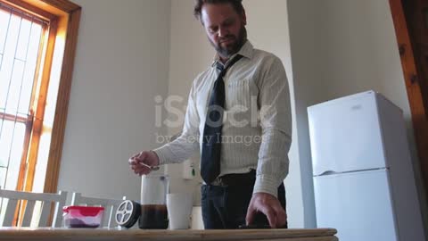 Man spills coffee all over the table while at work