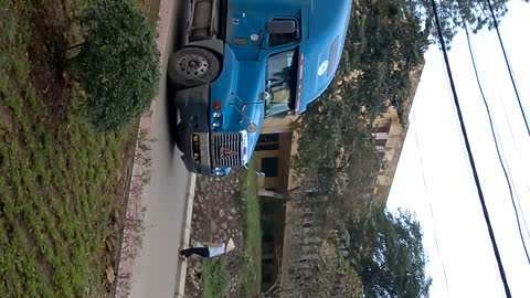 Container trucks downhill in curved road