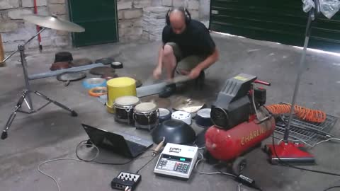 Performer uses garage items to create music