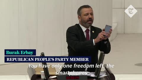 Turkish lawmaker smashes phone with hammer in parliament to protest social media bill