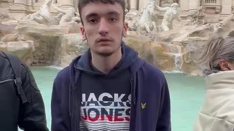 Guy Loses Balance Tossing Coin into Fountain