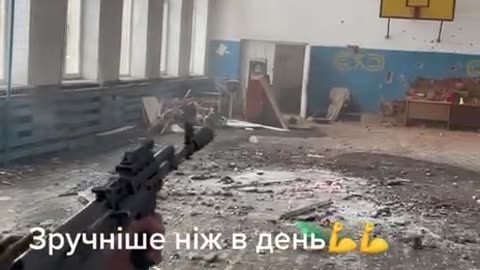 A Ukrainian "hero" with an American flag patch on his shoulder shoots a gun in a school building.