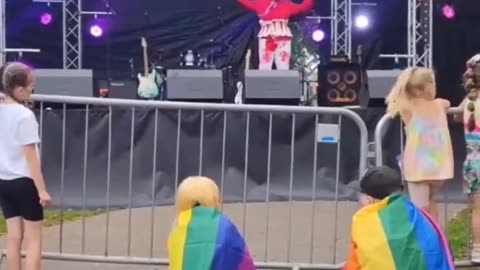 Drag Queen covered in blood throws tampons at children.