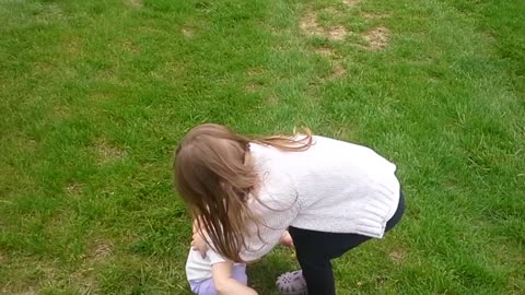 Emma giving Haley a dandelion