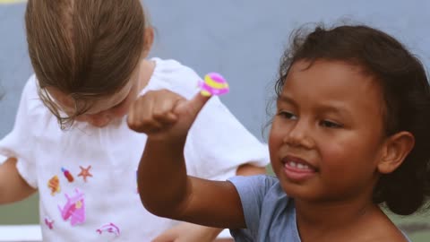 Girls Playing with Colorful Stickers