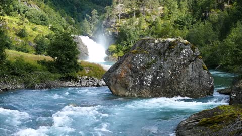 big stone in a clear blue river at morkidsdalen park skjolden norway