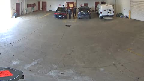 Watch How This Witty Perp Escapes Police Car Through Garage Doors