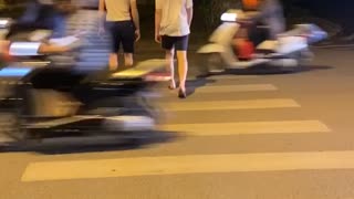 Daring Dudes Make a Harrowing Crossing in Hanoi