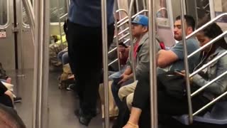 Guy blue shirt black pants doing pull ups in subway