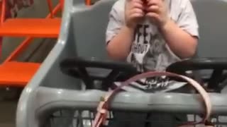 Little boy in grocery cart afraid of mickey mouse
