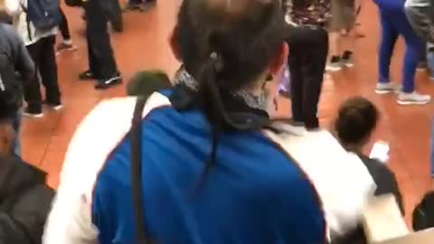 Man walking down subway station stairs little hair antennas