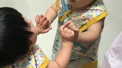 Cute baby fights with its own virtual image in a plane mirror and gets hurt in the process