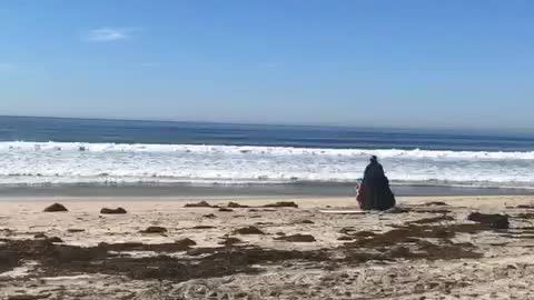 Guy black cape darthvader surf sand beach