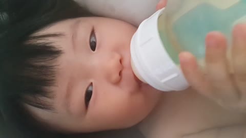Laughing babies while sucking bottle