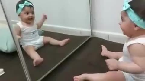 Very Cute Reaction of Baby while seeing Her reflection in the Mirror.