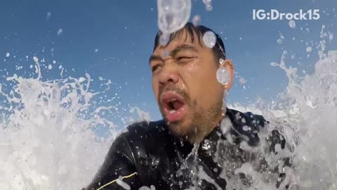 Surfing guy gets hit by wave behind him but recovers