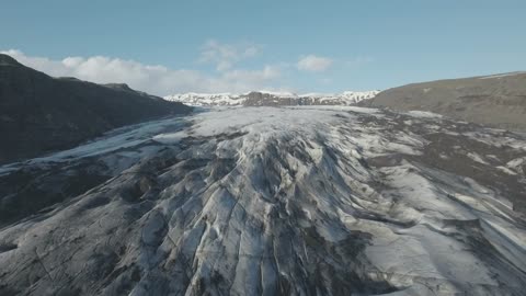 Drone flying towards a glacier