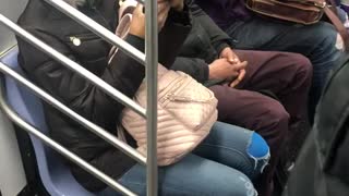 Man brushes his teeth on subway train