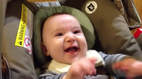 Baby Sawyer laughing at duck puppet