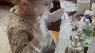 Little Girl Covers Herself in Lotion
