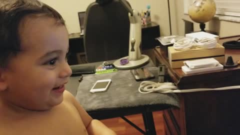 Baby cracking up at kitty cat videos