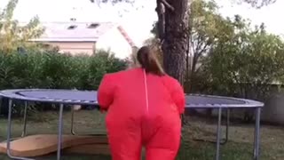 Girl red inflatable suit trampoline back flip