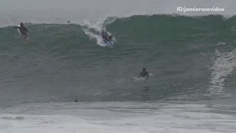 Guy blue surfboard wipes out huge wave