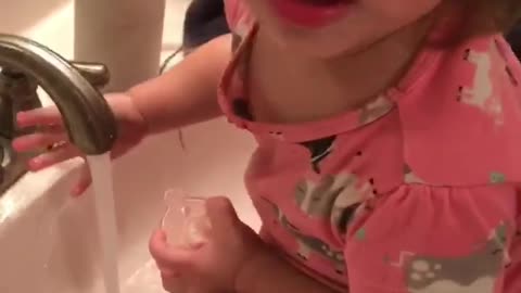 Toddler thinks she can grab the water!