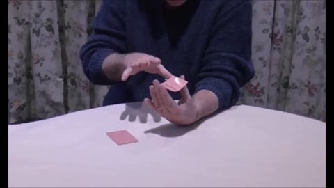 A Match Eerily Floats Suspended On A Playing Card