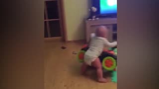 Baby falls on top of his scooter while pushing it. Cute/funny