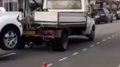 Maniacal tow truck driver damages several parked cars while dragging a car down the street