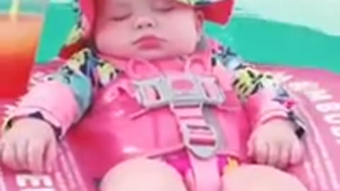 Cute baby sleeping in water