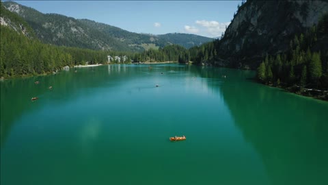 aerial footage over lake braies pragser wildsee and mountains in the background