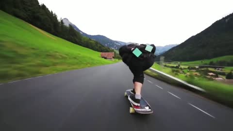 Outstanding longboard downhill with a jump and people