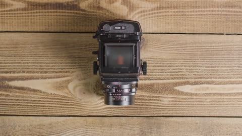 Top Down Shot of Person Opening Viewfinder On Mamiya RB67 Medium Format Film Camera