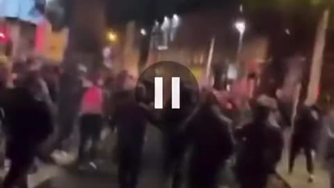 Irish rioters set a container on fire and use it to charge riot police lines in Dublin.