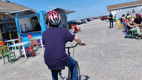 Spencer riding his tricycle at Jones beach air show VID_20230521_132721 VID_20230527_153126