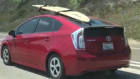 Red prius surfboard on roof