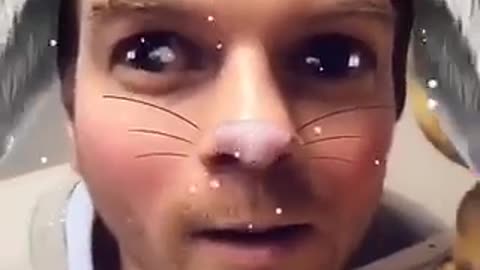 Guy puts face next to line of stuffed animals using snapchat filter