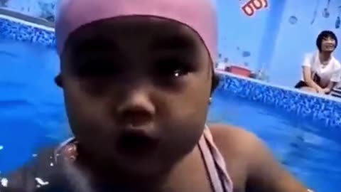 Very cute little baby swimming