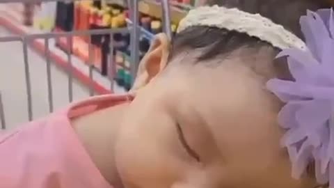 the baby is asleep on the trolley