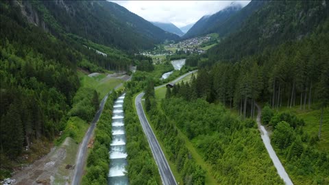 aerial view of mountain road along cascade river reveal beautiful alpine valley tirol austria