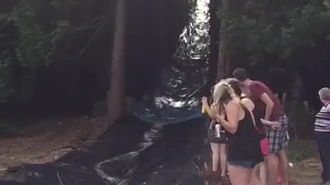Dog Learns Why It Is A Bad Idea To Cross A Water Slide
