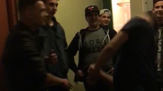 Music guy slaps his friend wearing black and knocks him to the ground