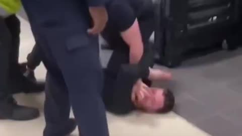 Man fighting with security, member of public takes things into his own hands.