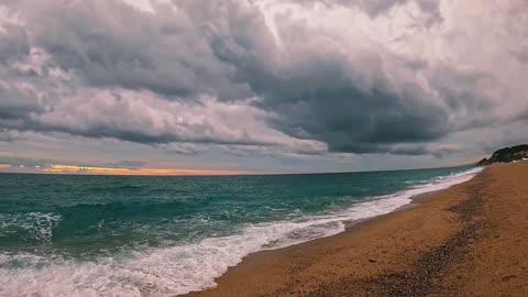 Overcast Serenity: Gentle Waves on a Secluded Beach