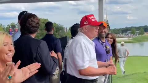 Trump, Tucker Carlson and MTG laughing together as the crowds at the golf chant "let's go Brandon".
