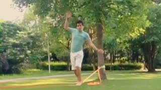 Guy green shirt white shorts slackline fail