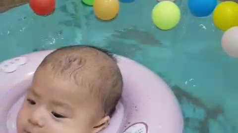 baby swimming in a small pool for the first time