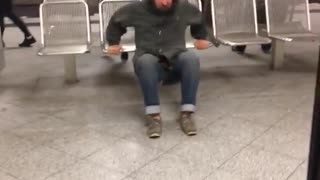 A man going up and down on subway station chair